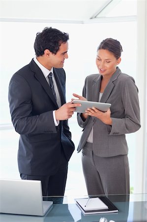 sales person with a tablet - Young business partner looking at tablet in their hands Stock Photo - Budget Royalty-Free & Subscription, Code: 400-05740332