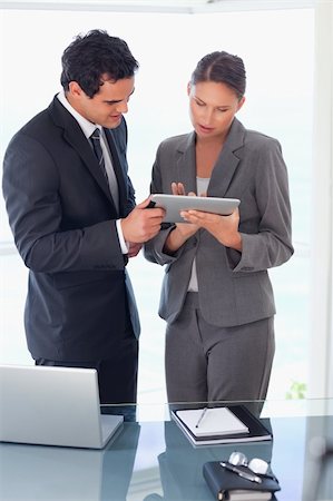 sales person with a tablet - Young tradesman explaining functionality of tablet to his colleague Stock Photo - Budget Royalty-Free & Subscription, Code: 400-05740333