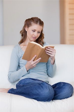 simsearch:400-05716909,k - Young woman on the sofa focused on her book Stock Photo - Budget Royalty-Free & Subscription, Code: 400-05740826