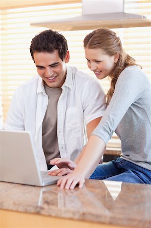 simsearch:400-05749531,k - Young couple surfing the web in the kitchen Stock Photo - Budget Royalty-Free & Subscription, Code: 400-05741106