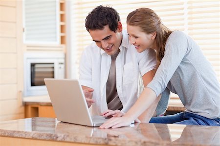 simsearch:400-05749531,k - Young couple surfing the internet in the kitchen Stock Photo - Budget Royalty-Free & Subscription, Code: 400-05741102