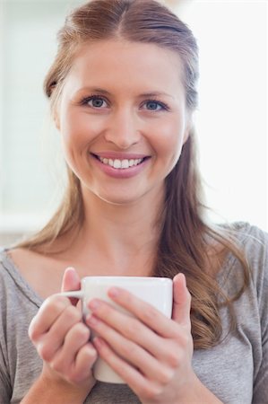 simsearch:400-05749531,k - Close up of smiling young woman with a cup of coffee Stock Photo - Budget Royalty-Free & Subscription, Code: 400-05741119