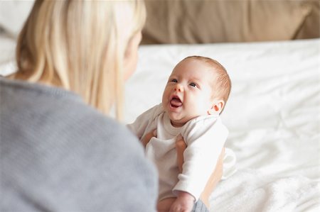 Young mother laying down her newborn Stock Photo - Budget Royalty-Free & Subscription, Code: 400-05741262