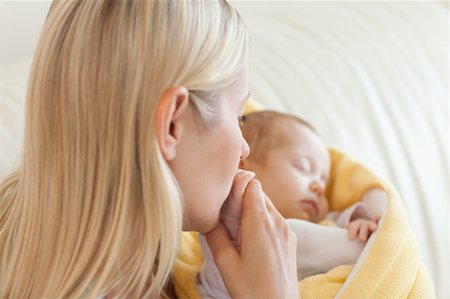 frühgeburt - Above view of young mother kissing her baby's hand Stockbilder - Microstock & Abonnement, Bildnummer: 400-05741325