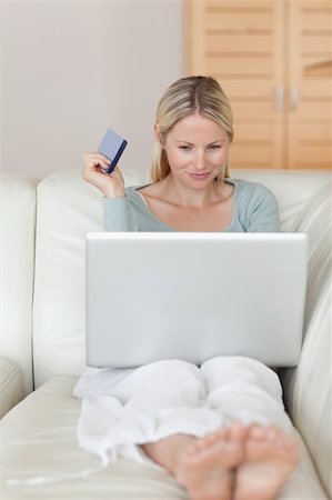 simsearch:6109-06195018,k - Young woman on the sofa booking flight online Stock Photo - Budget Royalty-Free & Subscription, Code: 400-05741359