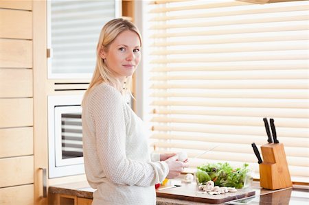 person chopping carrots - Young woman preparing vegetables for lunch Stock Photo - Budget Royalty-Free & Subscription, Code: 400-05741481