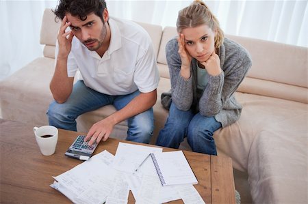 Worried couple doing their accounting in their living room Stock Photo - Budget Royalty-Free & Subscription, Code: 400-05741564