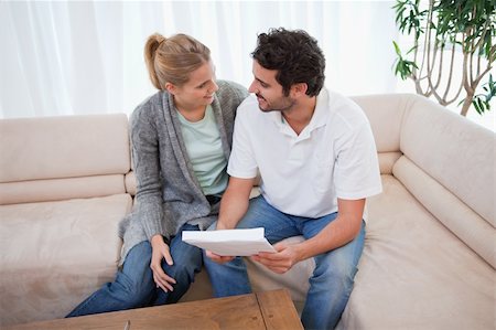 Young couple reading a letter in their living room Stock Photo - Budget Royalty-Free & Subscription, Code: 400-05741575