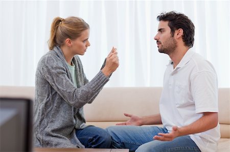 simsearch:400-05739935,k - Angry couple arguing in their living room Stock Photo - Budget Royalty-Free & Subscription, Code: 400-05741594