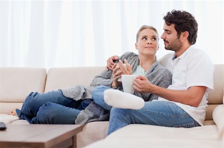Couple having a cup of coffee in their living room Stock Photo - Budget Royalty-Free & Subscription, Code: 400-05741784