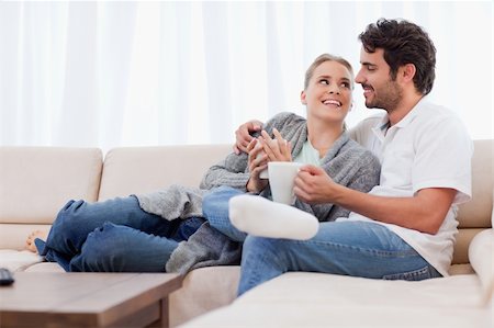 Young couple having a cup of coffee in their living room Stock Photo - Budget Royalty-Free & Subscription, Code: 400-05741785