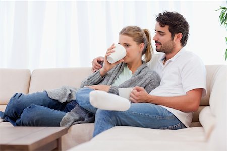 Young couple having a cup of tea in their living room Stock Photo - Budget Royalty-Free & Subscription, Code: 400-05741786