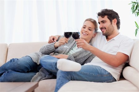 simsearch:400-04663577,k - Couple having a glass of red wine in their living room Stock Photo - Budget Royalty-Free & Subscription, Code: 400-05741794