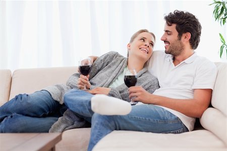 Young couple having a glass of red wine in their living room Stock Photo - Budget Royalty-Free & Subscription, Code: 400-05741795