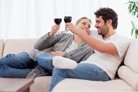 Young couple having a glass of wine in their living room Stock Photo - Budget Royalty-Free & Subscription, Code: 400-05741796