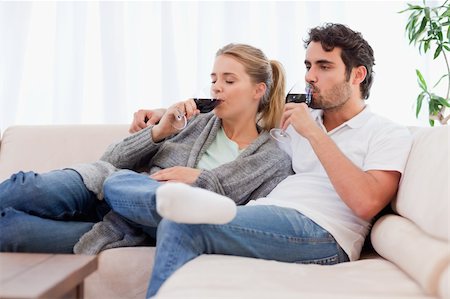 simsearch:400-04663577,k - Couple drinking a glass of wine in their living room Stock Photo - Budget Royalty-Free & Subscription, Code: 400-05741797