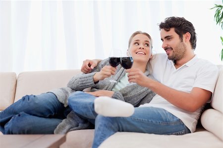 Couple having a glass of wine in their living room Stock Photo - Budget Royalty-Free & Subscription, Code: 400-05741793