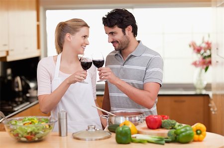 Lovely couple drinking a glass of wine in their kitchen Stock Photo - Budget Royalty-Free & Subscription, Code: 400-05741861