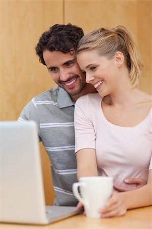simsearch:400-04335902,k - Portrait of a couple using a laptop while having tea in their kitchen Stock Photo - Budget Royalty-Free & Subscription, Code: 400-05741876