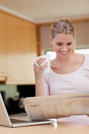 simsearch:400-05737647,k - Portrait of a woman reading the news while having tea in her kitchen Stock Photo - Budget Royalty-Free & Subscription, Code: 400-05741892