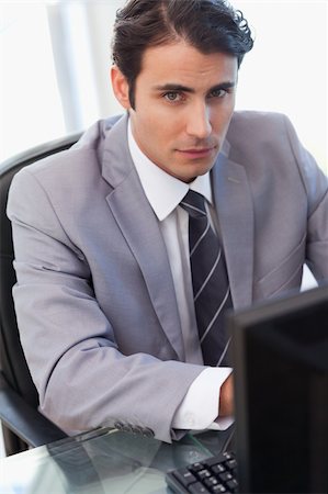 simsearch:400-05900668,k - Portrait of a serious businessman working with a computer in his office Stock Photo - Budget Royalty-Free & Subscription, Code: 400-05741948