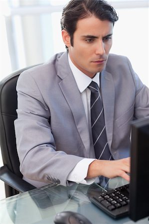 simsearch:400-05900668,k - Portrait of a focused businessman working with a computer in his office Stock Photo - Budget Royalty-Free & Subscription, Code: 400-05741949