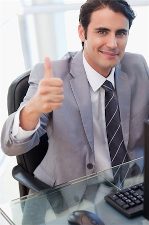 simsearch:400-05900668,k - Portrait of a businessman working with a computer with the thumb up in his office Stock Photo - Budget Royalty-Free & Subscription, Code: 400-05741950