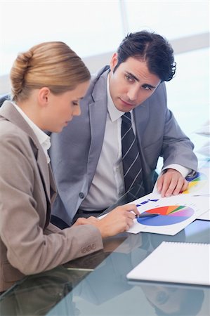 Portrait of young business people studying statistics in a meeting room Stock Photo - Budget Royalty-Free & Subscription, Code: 400-05741987