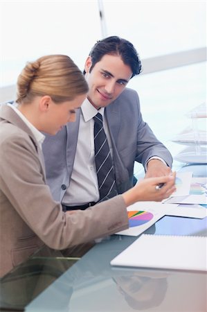 Portrait of business people looking at statistics in a meeting room Stock Photo - Budget Royalty-Free & Subscription, Code: 400-05741989