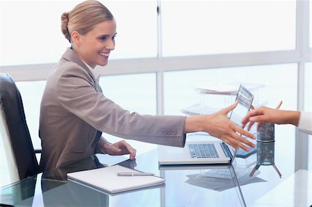simsearch:400-05034438,k - Smiling businesswoman receiving a customer in her office Stock Photo - Budget Royalty-Free & Subscription, Code: 400-05741981