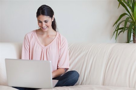 simsearch:400-05715528,k - Woman using a laptop in her living room Stock Photo - Budget Royalty-Free & Subscription, Code: 400-05742007