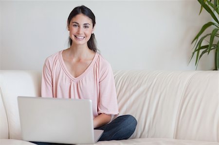 simsearch:400-04017977,k - Woman using a notebook in her living room Photographie de stock - Aubaine LD & Abonnement, Code: 400-05742008