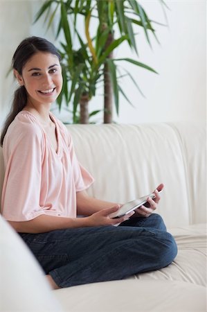 Portrait of a happy woman using a tablet computer in her living room Fotografie stock - Microstock e Abbonamento, Codice: 400-05742020