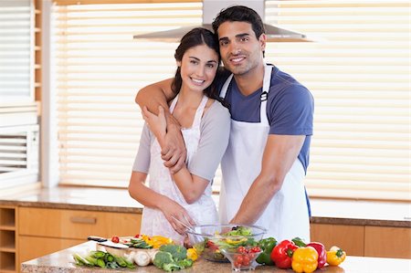 simsearch:400-04162443,k - Charming young couple posing in their kitchen Fotografie stock - Microstock e Abbonamento, Codice: 400-05742625