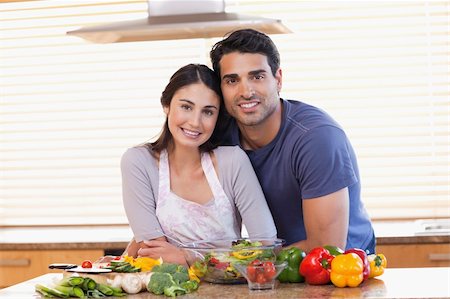 simsearch:400-04162443,k - Cute couple looking at the camera in their kitchen Fotografie stock - Microstock e Abbonamento, Codice: 400-05742630