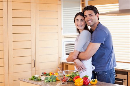 simsearch:400-04162443,k - Charming couple embracing each other in their kitchen Fotografie stock - Microstock e Abbonamento, Codice: 400-05742632