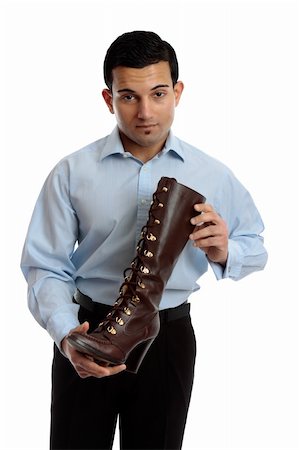 simsearch:400-04765778,k - A shoe salesman holding a brown leather lace up boot.  White background. Stock Photo - Budget Royalty-Free & Subscription, Code: 400-05742686