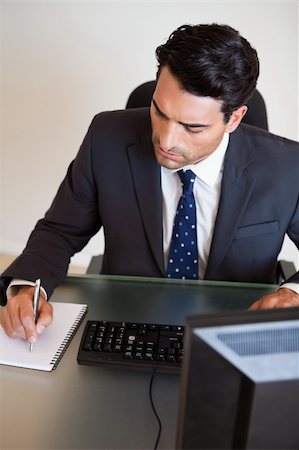 simsearch:400-05900668,k - Portrait of a businessman taking notes in his office Stock Photo - Budget Royalty-Free & Subscription, Code: 400-05742726