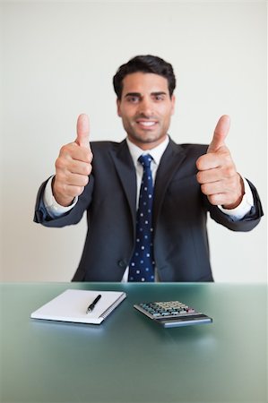 simsearch:400-07931035,k - Portrait of a young accountant with the thumbs up in his office Stock Photo - Budget Royalty-Free & Subscription, Code: 400-05742746