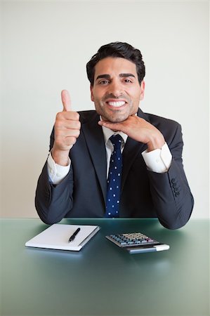 simsearch:400-04782141,k - Portrait of an accountant with the thumb up in his office Stock Photo - Budget Royalty-Free & Subscription, Code: 400-05742743
