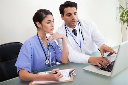 Young doctors working with a notebook in an office Stock Photo - Budget Royalty-Free & Subscription, Code: 400-05742800