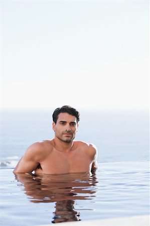 Portrait of a young man relaxing in a swimming pool Stock Photo - Budget Royalty-Free & Subscription, Code: 400-05742814