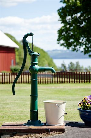 Old water pump with bucket in a farm Stock Photo - Budget Royalty-Free & Subscription, Code: 400-05742882