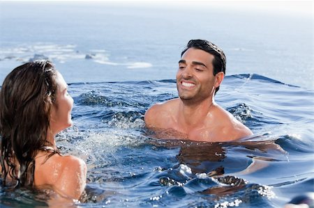 Smiling couple playing in a swimming pool Stock Photo - Budget Royalty-Free & Subscription, Code: 400-05742909