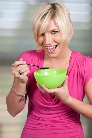 A beautiful woman eating food from a bowl Stock Photo - Budget Royalty-Free & Subscription, Code: 400-05743026