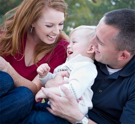 simsearch:400-04042848,k - Attractive Young Parents Laughing with their Child Boy in the Park. Fotografie stock - Microstock e Abbonamento, Codice: 400-05743774