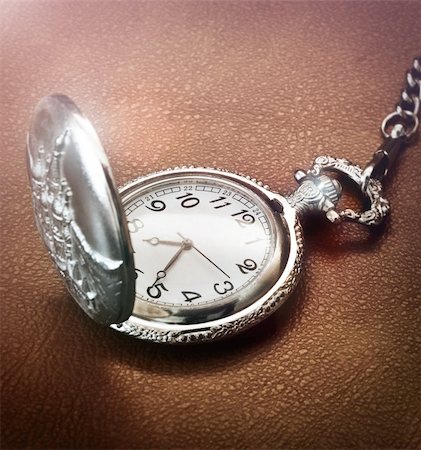 pocket watch - Close up of a pocket watch on brown texture Stock Photo - Budget Royalty-Free & Subscription, Code: 400-05754022