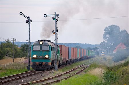 simsearch:400-07417657,k - Freight train hauled by the diesel locomotives starting from the station Fotografie stock - Microstock e Abbonamento, Codice: 400-05754310