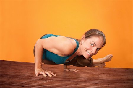 simsearch:400-04328141,k - Smiling Caucasian woman performs yoga on a wooden mat Stock Photo - Budget Royalty-Free & Subscription, Code: 400-05754642