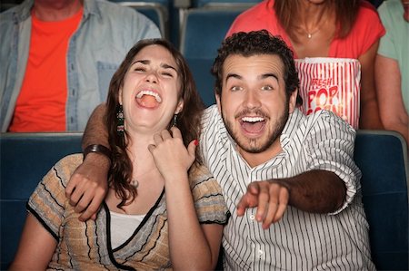 simsearch:400-06138368,k - Caucasian couple laugh out loud in theater Fotografie stock - Microstock e Abbonamento, Codice: 400-05754662